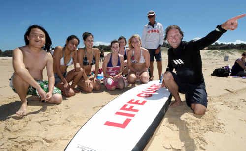 Lifeguards Sonny Tisdell and Greg Hackfath show international students how to stay safe at the beach. Lifeguards Sonny Tisdell and Greg Hackfath show international students how to stay safe at the beach.